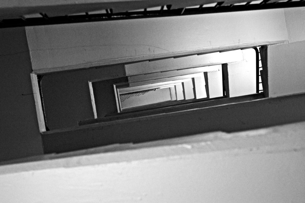 Looking up through the opening of stairwell in car park
