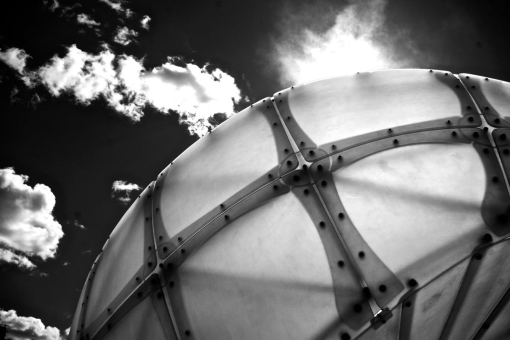 curve of public art installation in downtown calgary under cloudy summer sky