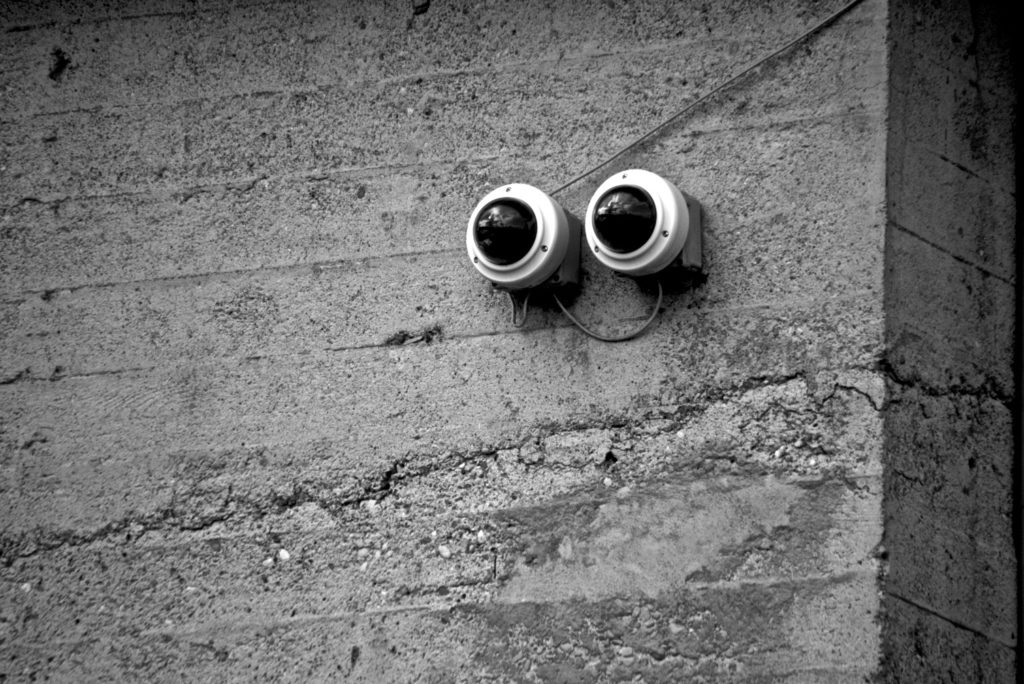 Pair of security cameras mounted on concrete wall