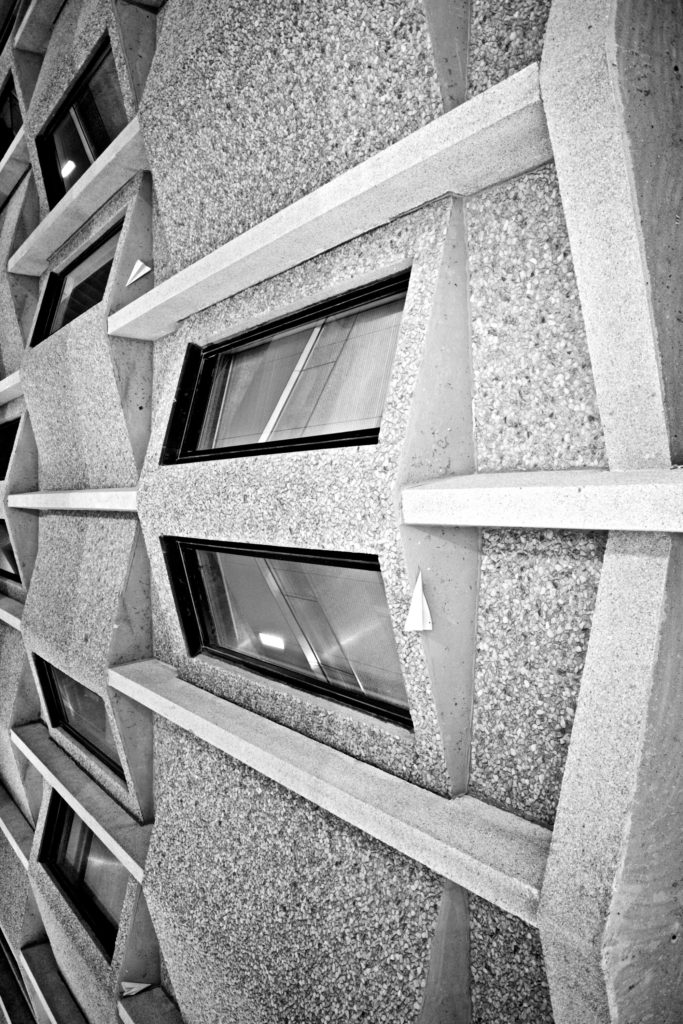 Brutalist architecture window detail with paper planes